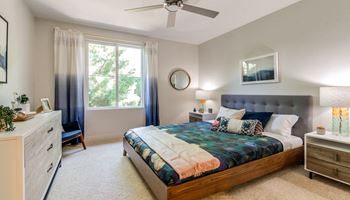 Bedroom with large window and ceiling fan